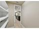 View of the kitchen from inside the pantry with white shelves and tile flooring at 4544 Vermillion Sky Dr, Wesley Chapel, FL 33544
