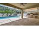 An outdoor patio showcases a built-in grill, ample space for entertaining, and a screened-in pool area at 4544 Vermillion Sky Dr, Wesley Chapel, FL 33544