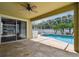 Enjoy this covered patio with ceiling fan overlooking the pool and spa, great for entertaining or relaxing at 4544 Vermillion Sky Dr, Wesley Chapel, FL 33544