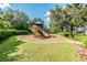 Community playground featuring slides, a small tower and wood chip ground covering at 4544 Vermillion Sky Dr, Wesley Chapel, FL 33544