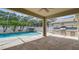 Outdoor living space with pool, waterfall feature, and built-in barbecue at 4544 Vermillion Sky Dr, Wesley Chapel, FL 33544