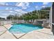 Enjoy this screened pool oasis with waterfall feature, spa, and lush landscaping for ultimate outdoor living at 4544 Vermillion Sky Dr, Wesley Chapel, FL 33544