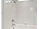 Shower-tub combo with white tiling, chrome fixtures and showerhead at 4544 Vermillion Sky Dr, Wesley Chapel, FL 33544