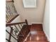 View of the staircase, with hardwood steps and an ornate wrought iron railing at 4544 Vermillion Sky Dr, Wesley Chapel, FL 33544