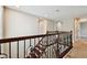 Staircase with dark wood steps and decorative iron railing leads to the second floor at 4544 Vermillion Sky Dr, Wesley Chapel, FL 33544