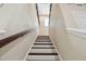 View of carpeted staircase with wood trim and decorative iron railing at 4544 Vermillion Sky Dr, Wesley Chapel, FL 33544