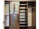 Well-organized walk-in closet with custom shelves, drawers, and cabinets at 4544 Vermillion Sky Dr, Wesley Chapel, FL 33544