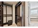 Bright and airy walk-in closet with custom organizers and a vanity area at 4544 Vermillion Sky Dr, Wesley Chapel, FL 33544