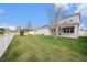 Spacious backyard featuring lush lawn, white picket fence, and a vibrant playset at 5027 Autumn Ridge Dr, Wesley Chapel, FL 33545