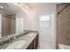 Bright bathroom featuring double vanity with granite countertop and a tiled walk-in shower at 5027 Autumn Ridge Dr, Wesley Chapel, FL 33545