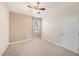 Neutral bedroom featuring carpet, a ceiling fan, and a window with natural light at 5027 Autumn Ridge Dr, Wesley Chapel, FL 33545