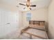 Neutral bedroom featuring carpet, a ceiling fan, a window, and an unfinished bed frame at 5027 Autumn Ridge Dr, Wesley Chapel, FL 33545