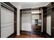 Walk in closet with custom shelving and hardwood floors at 5027 Autumn Ridge Dr, Wesley Chapel, FL 33545