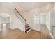Bright foyer showcasing hardwood floors, a staircase, and french doors to another room at 5027 Autumn Ridge Dr, Wesley Chapel, FL 33545