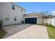 Attached garage with a blue door and a wide driveway provides ample parking at 5027 Autumn Ridge Dr, Wesley Chapel, FL 33545