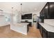 Modern kitchen featuring granite countertops, a large island, and sleek black appliances at 5027 Autumn Ridge Dr, Wesley Chapel, FL 33545