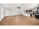 Spacious living room with hardwood floors and ceiling fan, open to the kitchen and dining areas at 5027 Autumn Ridge Dr, Wesley Chapel, FL 33545