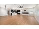 Open-concept living area with hardwood floors, modern fireplace, and stylish lighting fixtures at 5027 Autumn Ridge Dr, Wesley Chapel, FL 33545