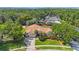 Stunning aerial view of a property with a large home, lush trees, and a private pool area at 512 Crystal Grove Blvd, Lutz, FL 33548