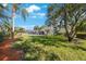 Beautiful backyard featuring mature trees, patio with furniture and screened-in lanai at 512 Crystal Grove Blvd, Lutz, FL 33548