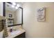 Cozy bathroom featuring a granite countertop, decorative mirror, and a charming 'Live Simply' wall art at 512 Crystal Grove Blvd, Lutz, FL 33548