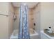 Bathtub with decorative tiling, a shower head, and storage shelves at 512 Crystal Grove Blvd, Lutz, FL 33548