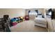 Bedroom with a trundle bed, exercise machine, and neutral decor at 512 Crystal Grove Blvd, Lutz, FL 33548