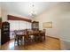 Cozy dining room with a wooden table, chandelier, and a china cabinet near a window at 512 Crystal Grove Blvd, Lutz, FL 33548