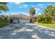 Attractive home showcasing a spacious driveway leading to a three-car garage at 512 Crystal Grove Blvd, Lutz, FL 33548