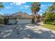 Charming home showcasing a spacious three-car garage, beautiful landscaping, and a welcoming front entrance at 512 Crystal Grove Blvd, Lutz, FL 33548