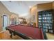 Spacious game room featuring a pool table, grand piano, and built-in bookshelves at 512 Crystal Grove Blvd, Lutz, FL 33548