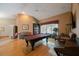 Large game room featuring a pool table, piano, hardwood floors, and views to the exterior at 512 Crystal Grove Blvd, Lutz, FL 33548