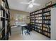 Inviting home office features wall-to-wall bookshelves, neutral decor, and a ceiling fan at 512 Crystal Grove Blvd, Lutz, FL 33548