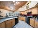 Spacious kitchen featuring stainless appliances, wood ceiling, breakfast bar, and natural lighting at 512 Crystal Grove Blvd, Lutz, FL 33548