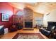 Bright living room featuring a wood-burning fireplace and hearth with a skylight above at 512 Crystal Grove Blvd, Lutz, FL 33548