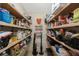 Walk-in pantry features shelving packed with lots of food and supplies, maximizing storage at 512 Crystal Grove Blvd, Lutz, FL 33548
