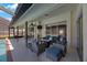 The covered patio includes comfortable seating, a ceiling fan, and an outdoor TV for relaxing and entertaining at 512 Crystal Grove Blvd, Lutz, FL 33548