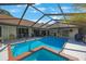 Screened-in pool featuring a spa, inviting backyard setup for relaxing and entertaining at 512 Crystal Grove Blvd, Lutz, FL 33548