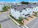 Aerial view of a three-story townhome featuring a two car garage and manicured lawn at 5351 Bridge St # 16, Tampa, FL 33611