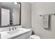 Neutral bathroom with a white quartz countertop vanity and a shower reflected in the mirror at 5351 Bridge St # 16, Tampa, FL 33611
