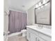 Bright bathroom featuring a modern vanity, white countertop, and a shower with a stylish gray curtain at 5351 Bridge St # 16, Tampa, FL 33611
