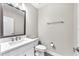 Well-lit half bathroom features a white sink, mirror, toilet, and neutral walls with a towel bar at 5351 Bridge St # 16, Tampa, FL 33611