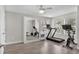 Bright bedroom with hard floors, ceiling fan, and fitness equipment including a mirror, treadmill, and exercise bikes at 5351 Bridge St # 16, Tampa, FL 33611