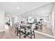 Bright dining room features wood floors, dining table with seating, and expansive mirrored wall reflecting the kitchen at 5351 Bridge St # 16, Tampa, FL 33611