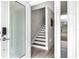 View of stairs with wood treads and white risers seen from the front door at 5351 Bridge St # 16, Tampa, FL 33611