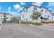 Three-story home features a white exterior, two car garage, and manicured lawn at 5351 Bridge St # 16, Tampa, FL 33611