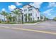 View of a modern, three-story townhome community with lush landscaping at 5351 Bridge St # 16, Tampa, FL 33611