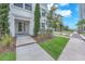 Inviting front entrance with lush green lawn, manicured landscaping and charming architectural details at 5351 Bridge St # 16, Tampa, FL 33611