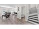 Open-concept hallway with staircase leading to the upper level, with half bath, dining area and kitchen views at 5351 Bridge St # 16, Tampa, FL 33611