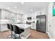 Bright kitchen featuring white cabinetry, stainless steel appliances, and modern bar stool seating at 5351 Bridge St # 16, Tampa, FL 33611